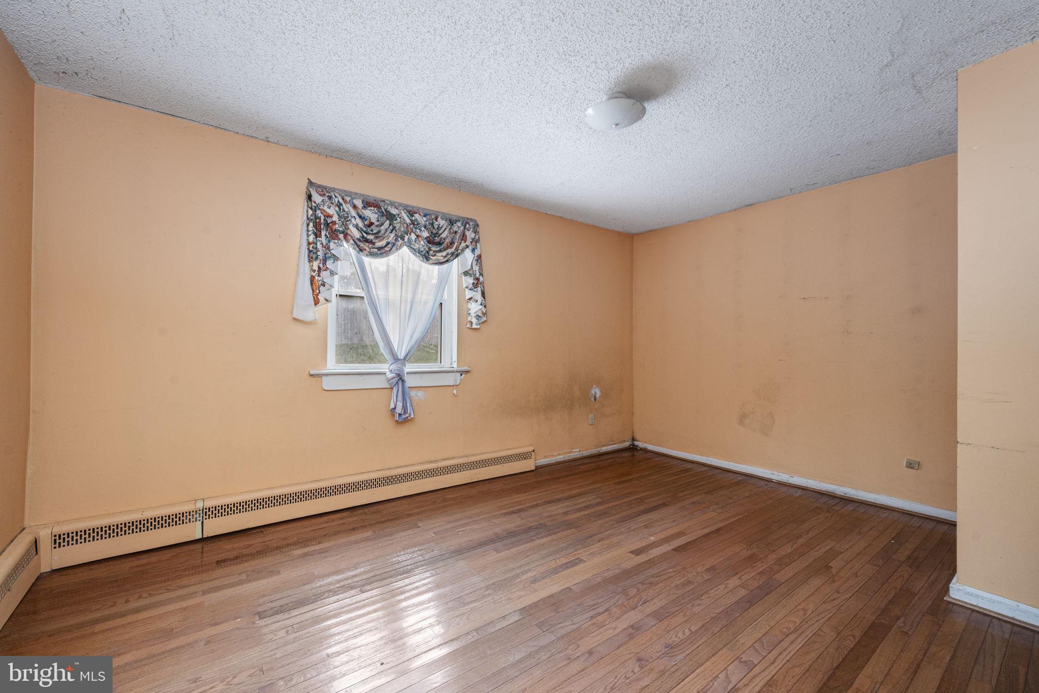 1016 West Boot Road Downingtown, PA 19335 - Photo 14 of 30 an empty room with wooden floor and a window