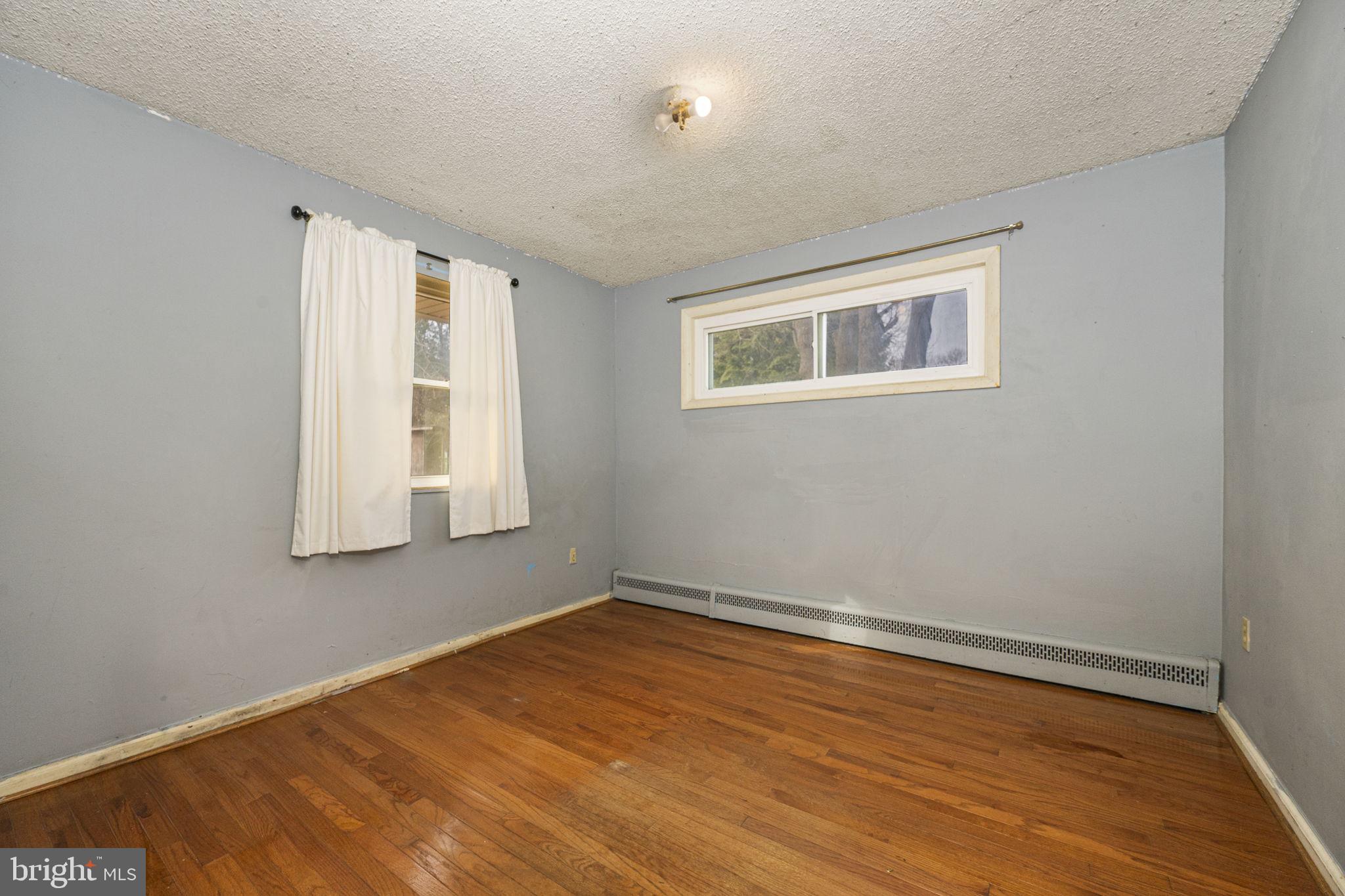 1016 West Boot Road Downingtown, PA 19335 - Photo 17 of 30 a view of empty room with wooden floor and fan