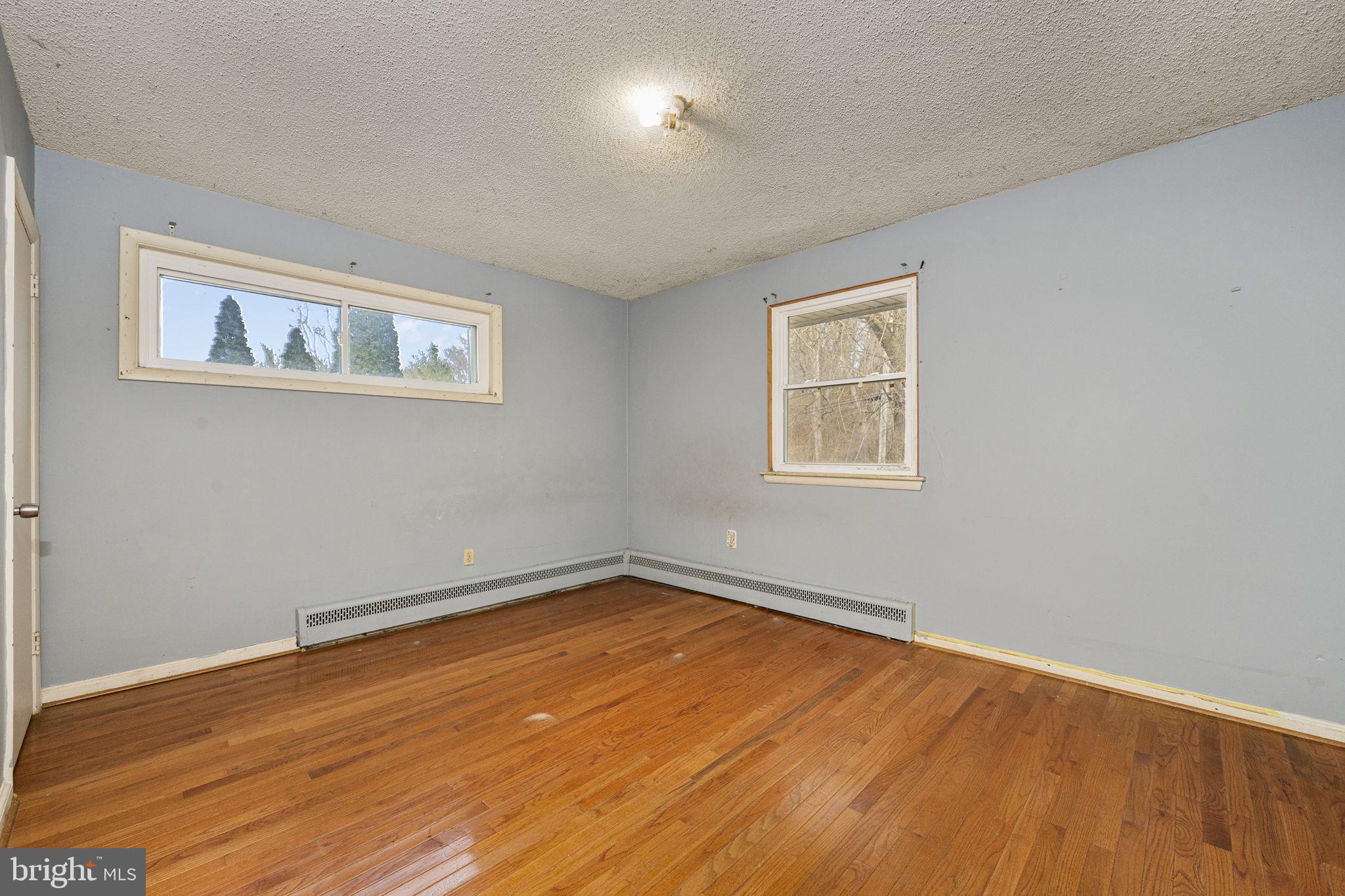 1016 West Boot Road Downingtown, PA 19335 - Photo 18 of 30 a view of an empty room with wooden floor and a window