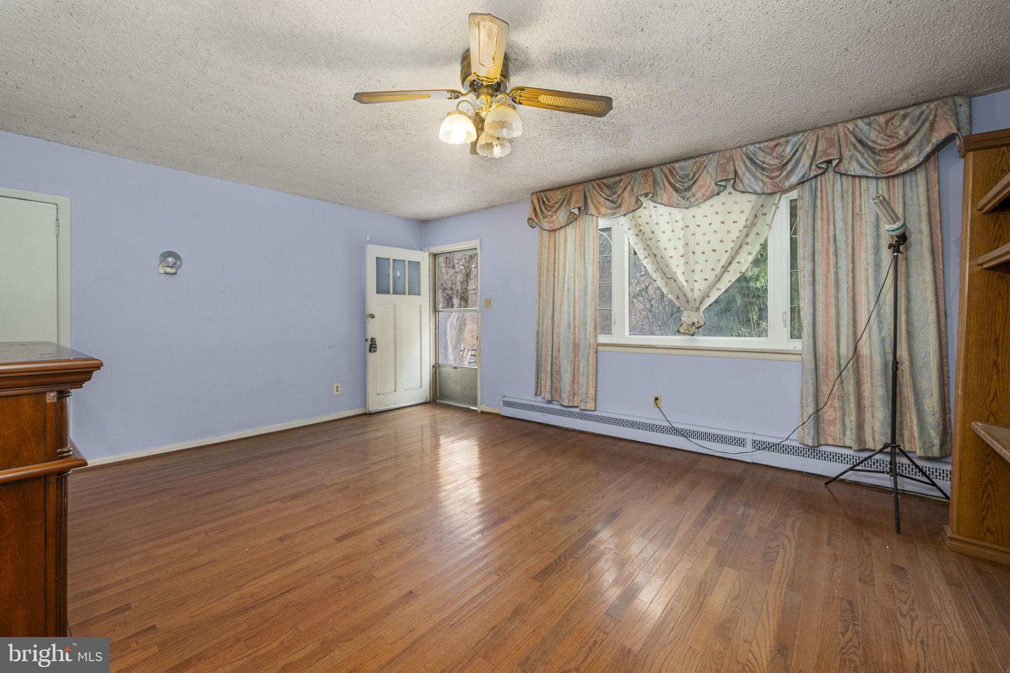 1016 West Boot Road Downingtown, PA 19335 - Photo 5 of 30 an empty room with wooden floor fan and windows