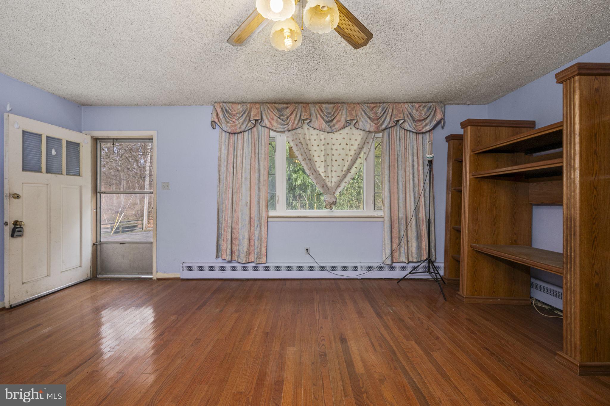 1016 West Boot Road Downingtown, PA 19335 - Photo 6 of 30 an empty room with wooden floor and windows