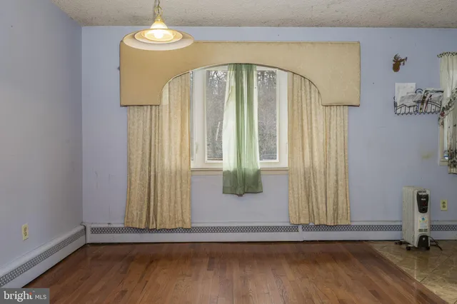 a view of a livingroom with wooden floor and door