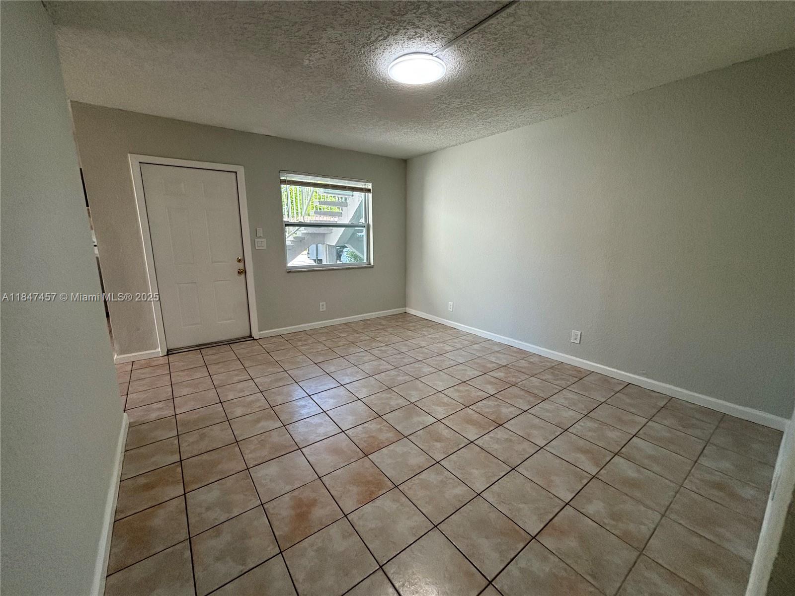 7921 Northwest 44th Court, Unit 2 Coral Springs, FL 33065 - Photo 4 of 11 an empty room with windows