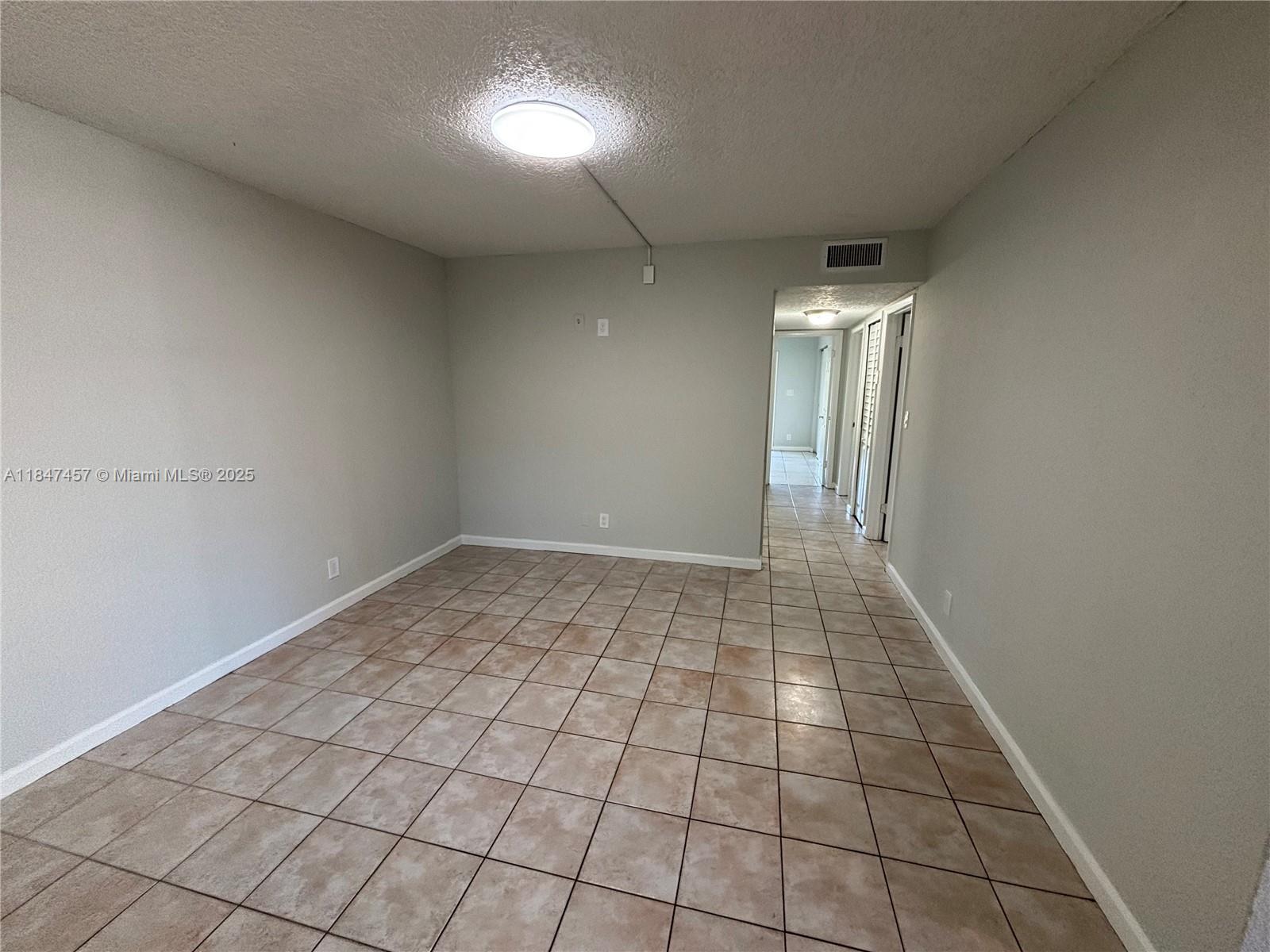 7921 Northwest 44th Court, Unit 2 Coral Springs, FL 33065 - Photo 5 of 11 a view of an empty room and window
