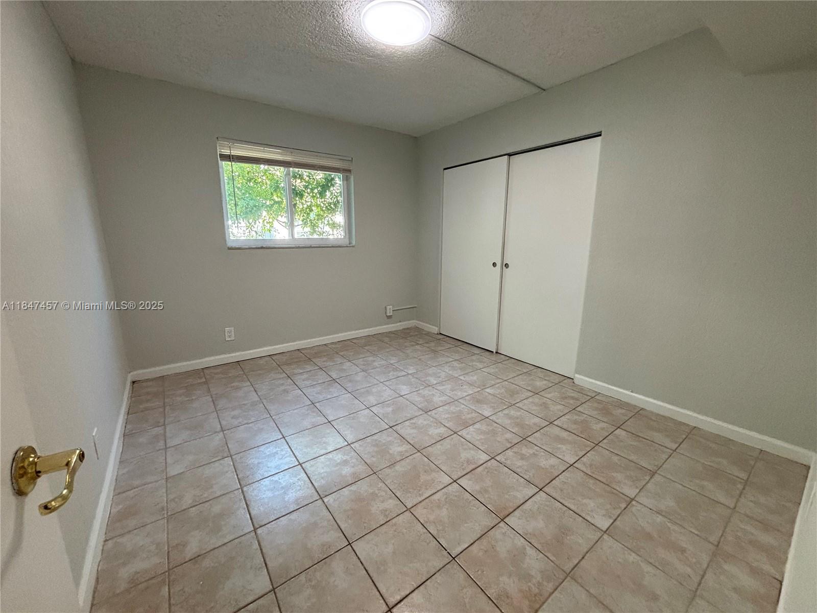 7921 Northwest 44th Court, Unit 2 Coral Springs, FL 33065 - Photo 6 of 11 an empty room with windows