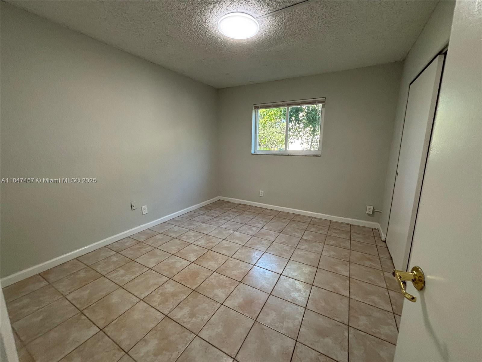 7921 Northwest 44th Court, Unit 2 Coral Springs, FL 33065 - Photo 7 of 11 a view of an empty room and window