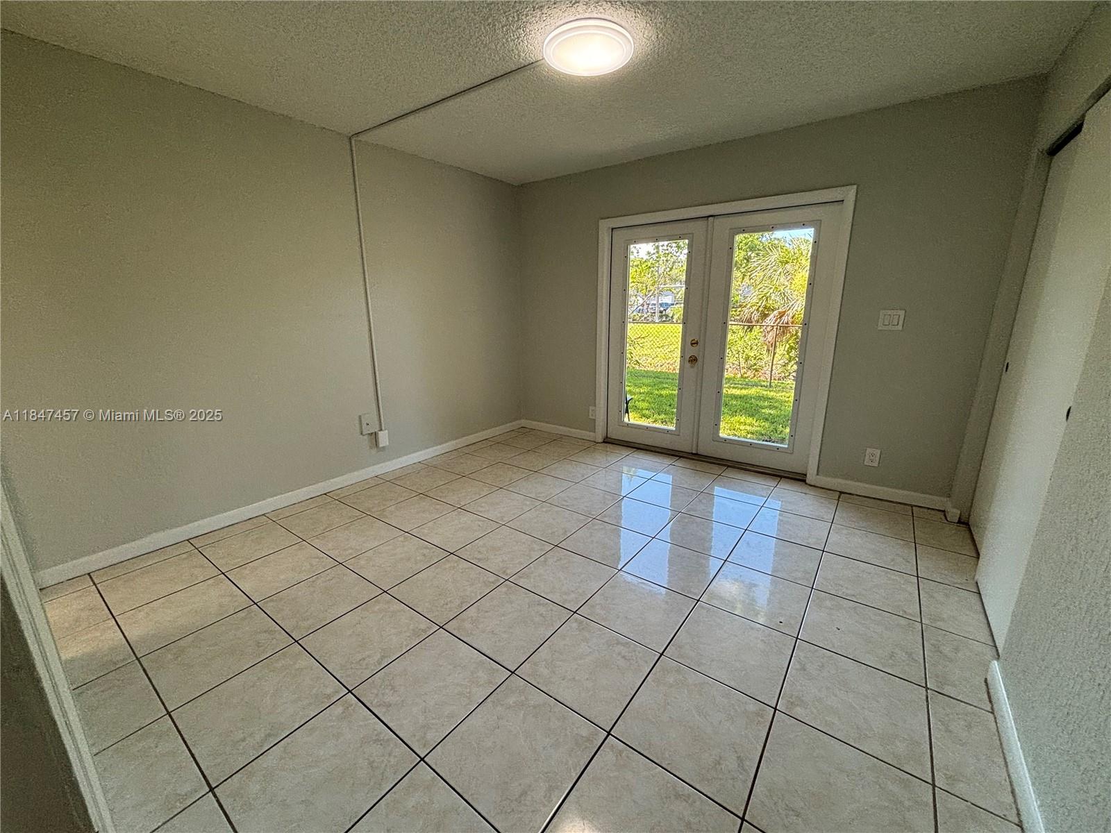 7921 Northwest 44th Court, Unit 2 Coral Springs, FL 33065 - Photo 9 of 11 a view of an empty room with a window