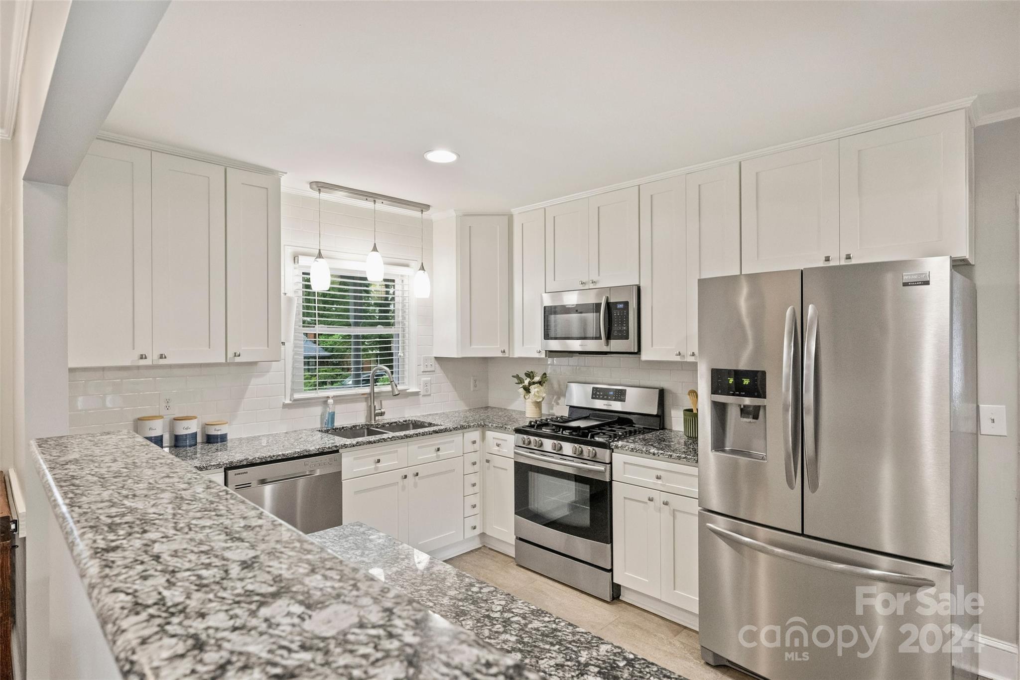 515 Bartling Road Charlotte, NC 28209 - Photo 11 of 42 a kitchen with granite countertop a sink stainless steel appliances and window