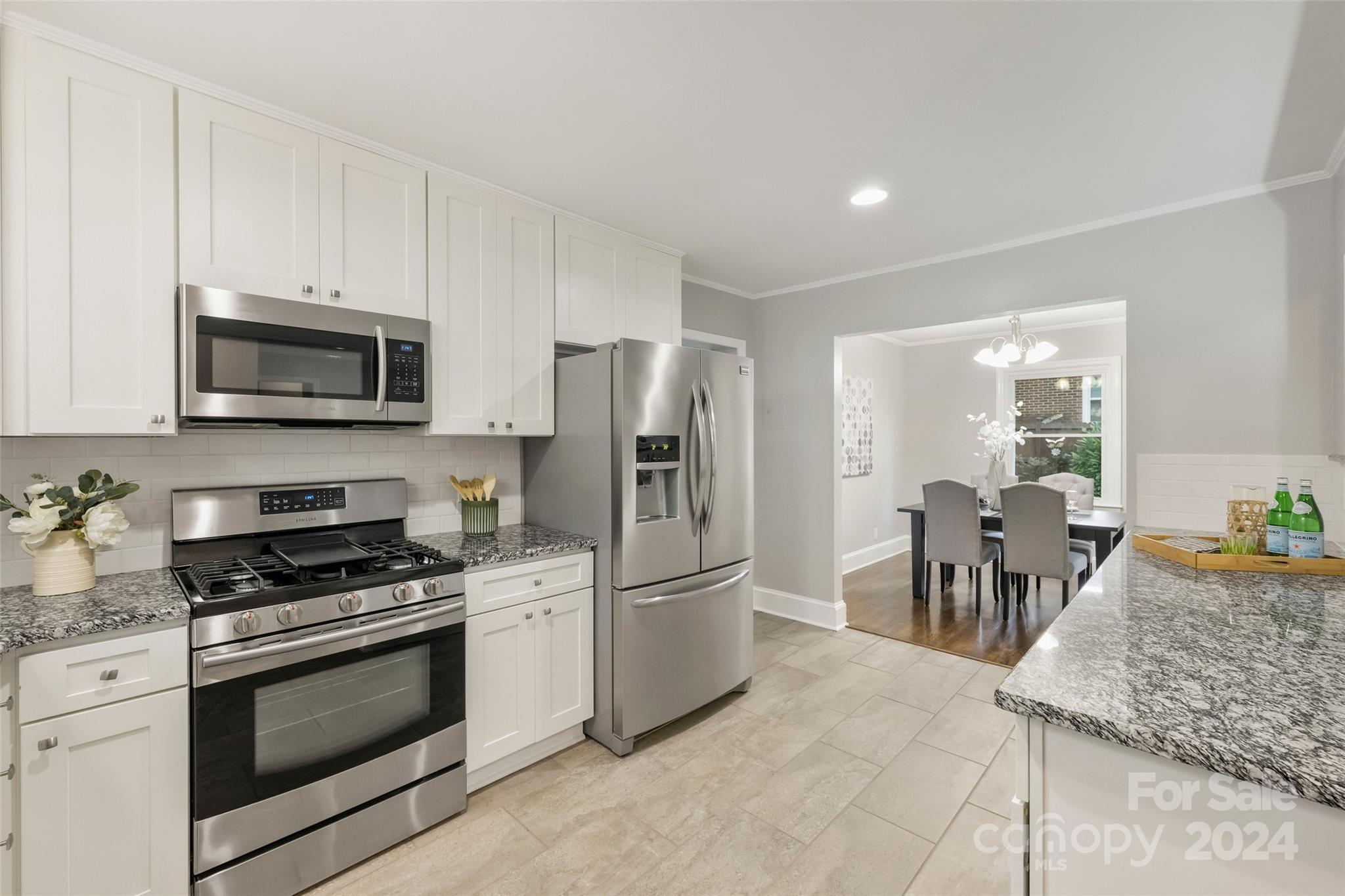515 Bartling Road Charlotte, NC 28209 - Photo 12 of 42 a kitchen with granite countertop a refrigerator stove and microwave
