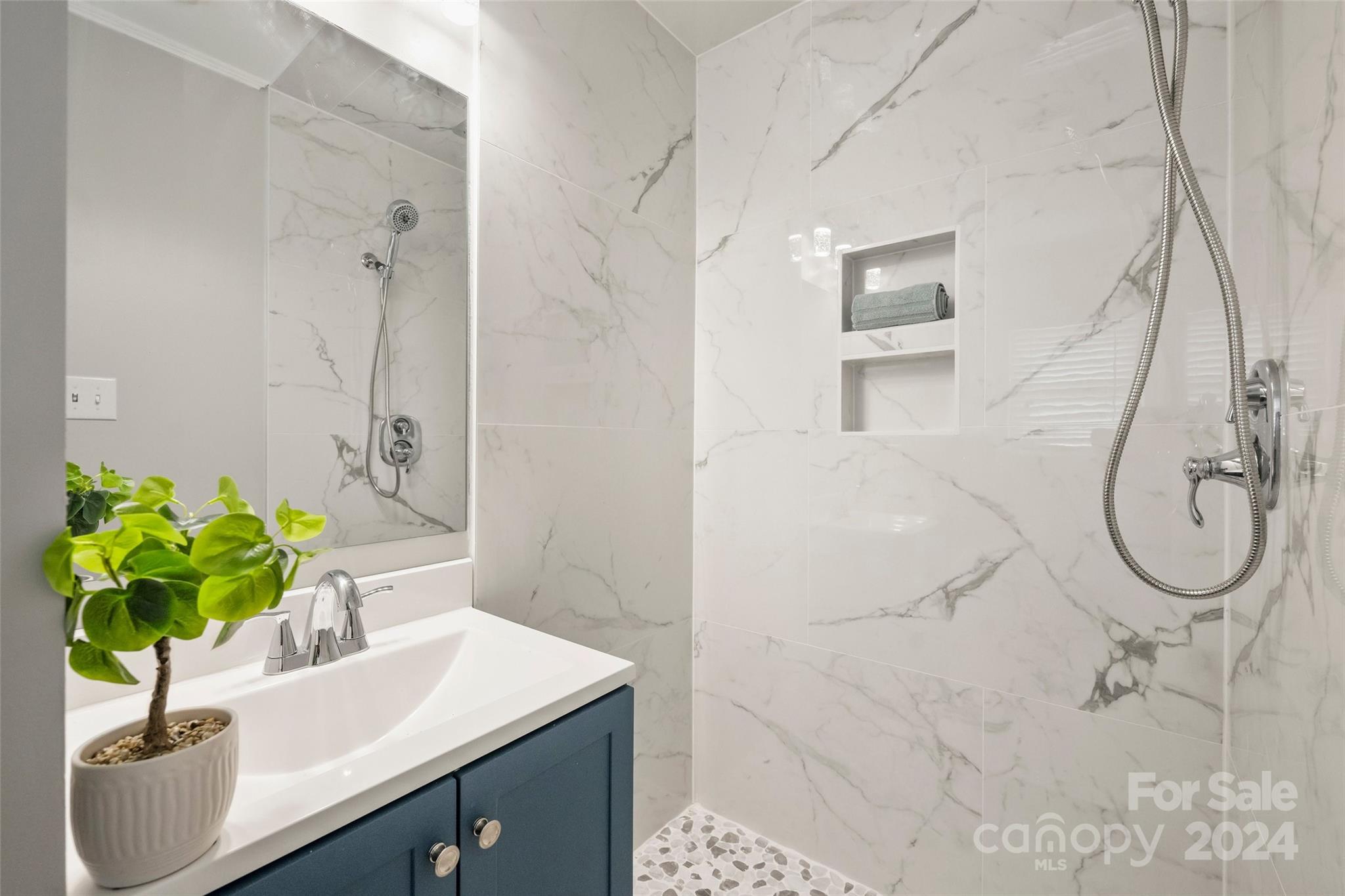 515 Bartling Road Charlotte, NC 28209 - Photo 22 of 42 a bathroom with a sink a toilet and a mirror