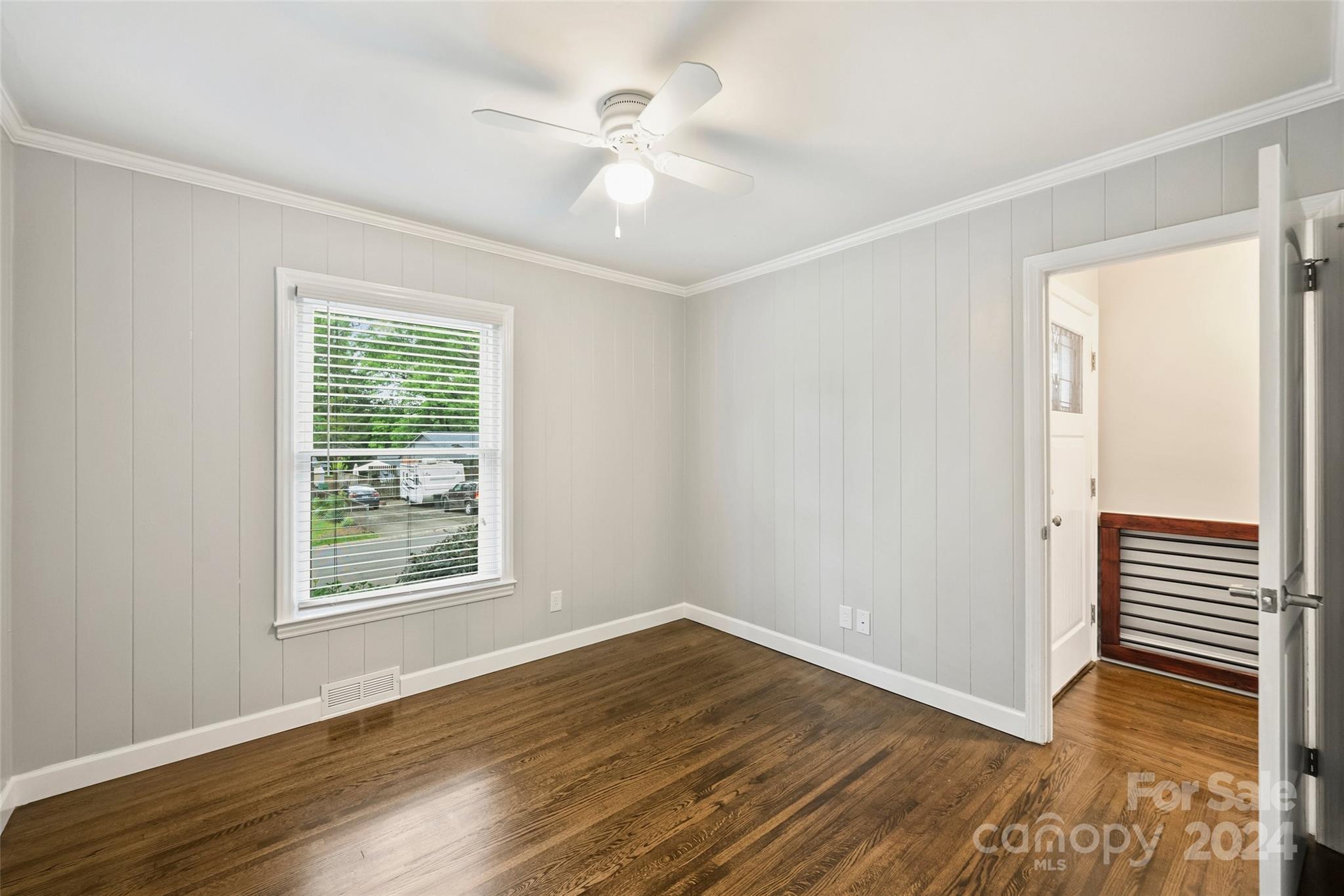 515 Bartling Road Charlotte, NC 28209 - Photo 24 of 42 a view of an empty room with wooden floor and a window