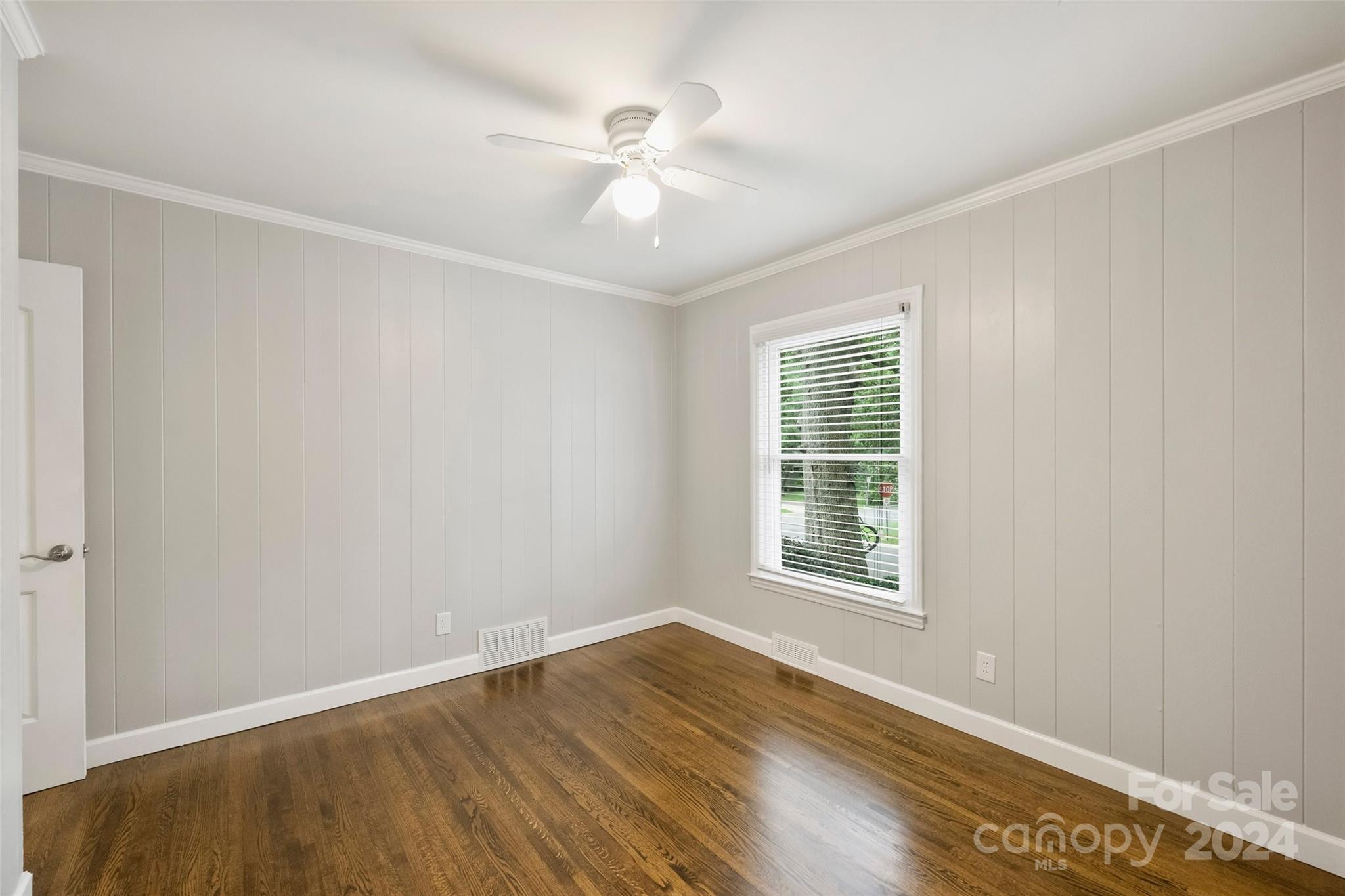 515 Bartling Road Charlotte, NC 28209 - Photo 25 of 42 a view of an empty room with wooden floor and a window