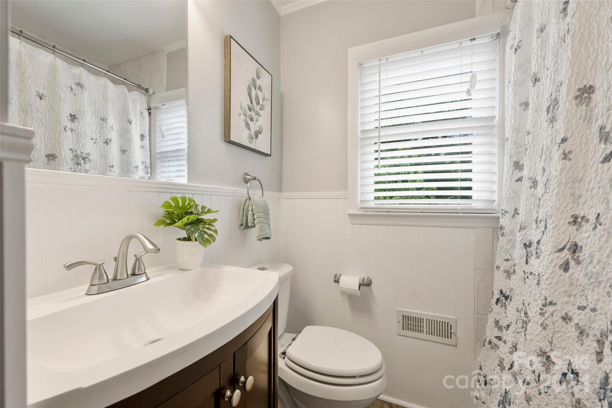 515 Bartling Road Charlotte, NC 28209 - Photo 27 of 42 a bathroom with a sink a toilet and a mirror