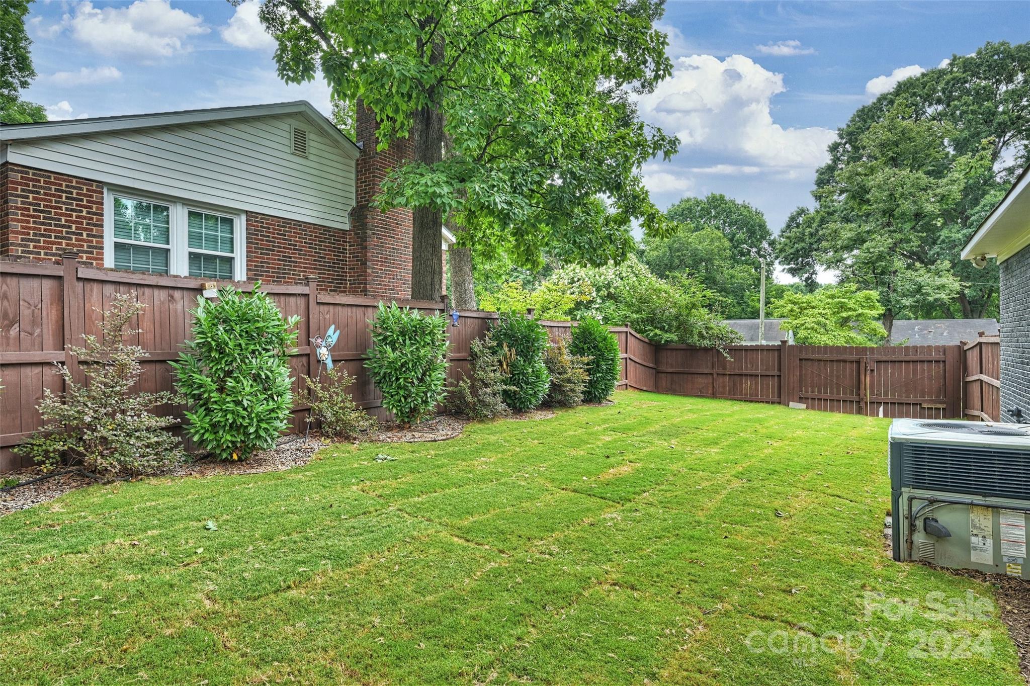 515 Bartling Road Charlotte, NC 28209 - Photo 39 of 42 a view of a backyard with table and chairs potted plants and large tree