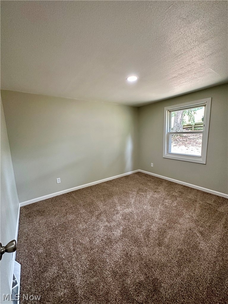 48963 Bloomfield Road East Liverpool, OH 43920 - Photo 19 of 25 Carpeted spare room with a textured ceiling
