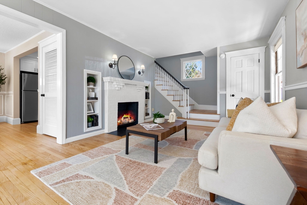 17 Coolidge Street Stoneham, MA 02180 - Photo 17 of 37 a living room with furniture and a fireplace