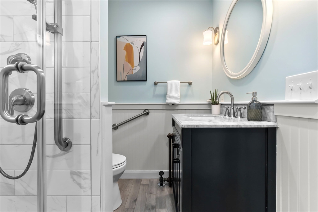 17 Coolidge Street Stoneham, MA 02180 - Photo 26 of 37 a bathroom with a sink vanity mirror and toilet