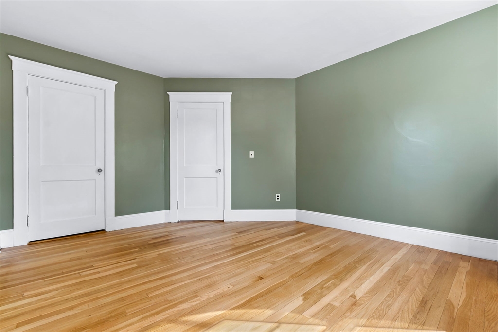 17 Coolidge Street Stoneham, MA 02180 - Photo 28 of 37 a view of an empty room with wooden floor