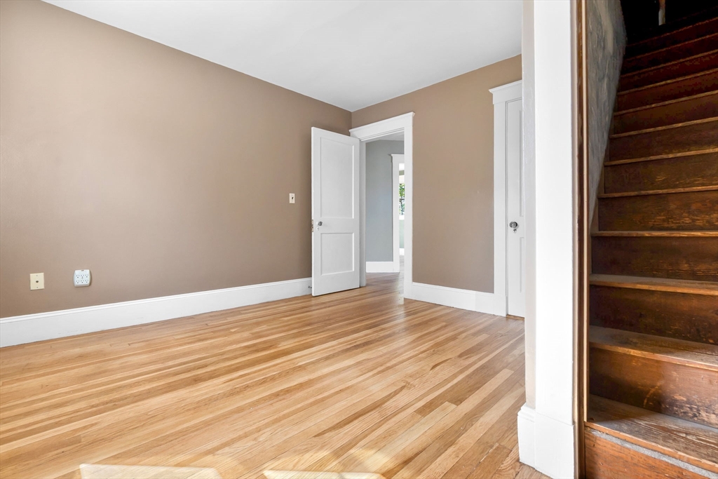 17 Coolidge Street Stoneham, MA 02180 - Photo 32 of 37 a view of an empty room with wooden floor and a window