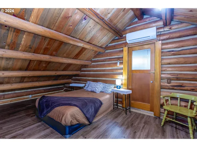 a bed room with a bed and a chair