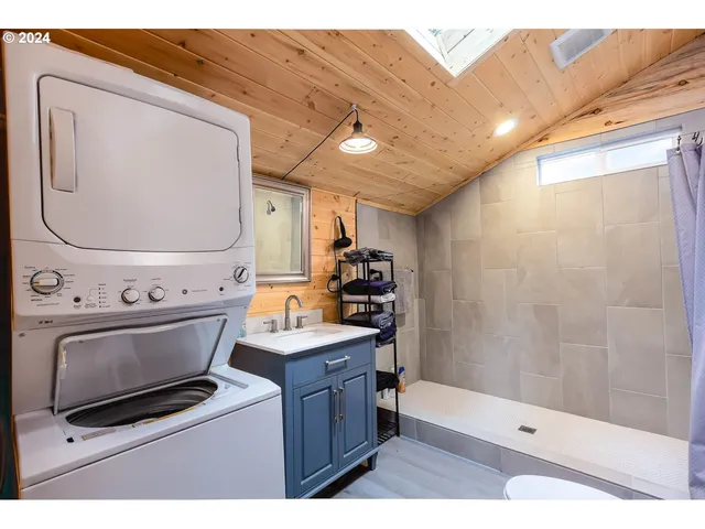 a backyard of a house with table and sofas