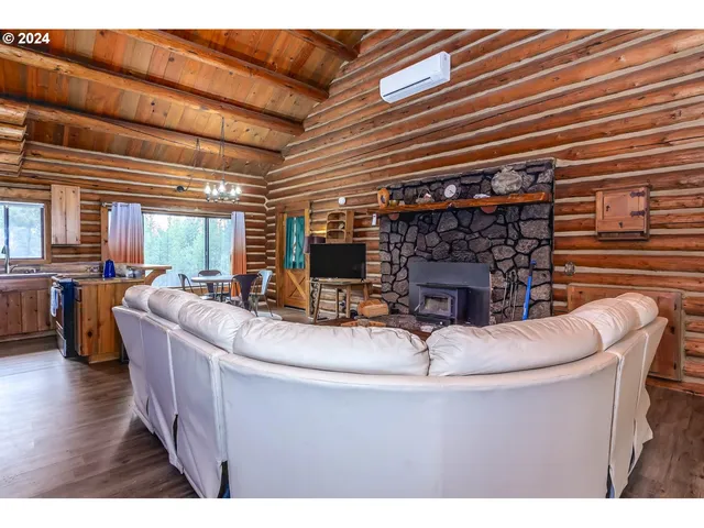 a living room with fireplace furniture and a wooden floor