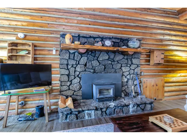a living room with fireplace and a wooden floor