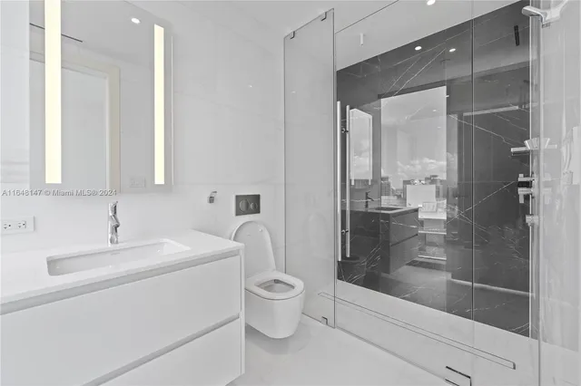a bathroom with a glass shower door