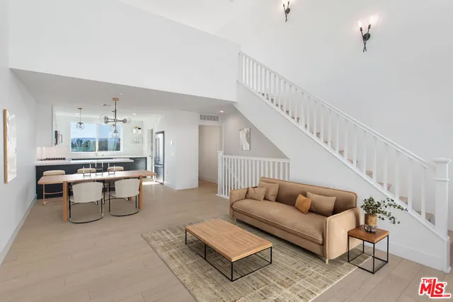 a living room with furniture and a dining table