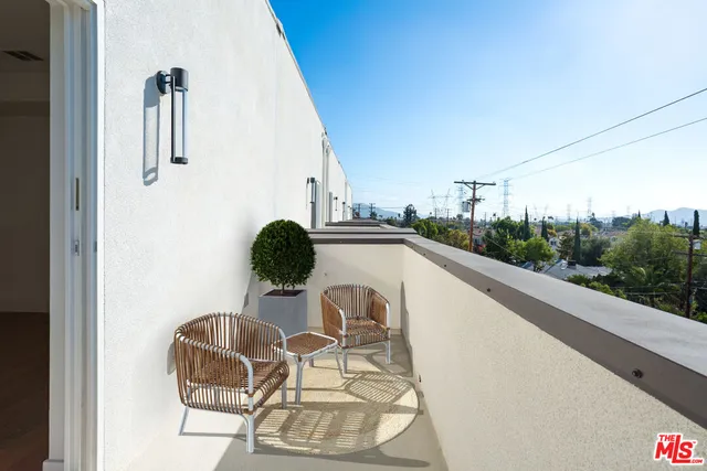 a picture of a table and chair in the balcony