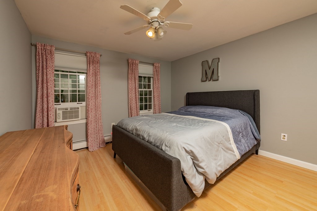 49 Point Of Pines Road Freetown, MA 02717 - Photo 15 of 32 a bedroom with a large bed chandelier and a window