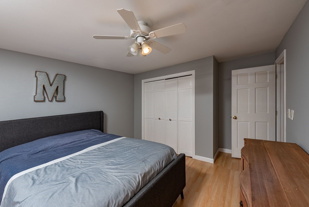 49 Point Of Pines Road Freetown, MA 02717 - Photo 16 of 32 a bedroom with a bed and a chandelier