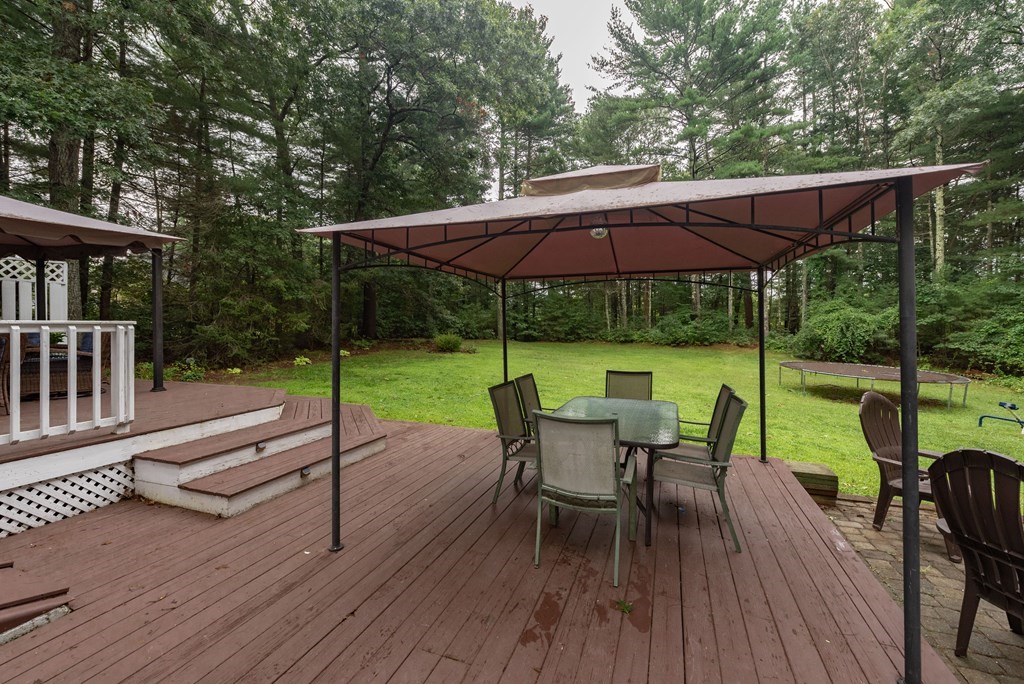 49 Point Of Pines Road Freetown, MA 02717 - Photo 25 of 32 a view of a patio with a table chairs and a backyard