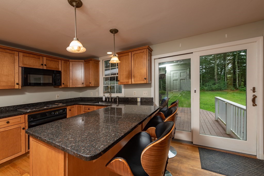 49 Point Of Pines Road Freetown, MA 02717 - Photo 4 of 32 a kitchen with stainless steel appliances granite countertop a sink a stove and a microwave