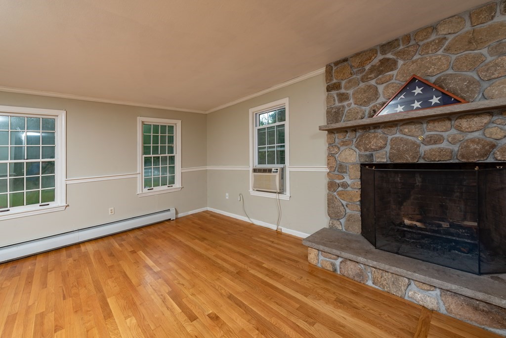 49 Point Of Pines Road Freetown, MA 02717 - Photo 9 of 32 a view of an empty room with a fireplace and window