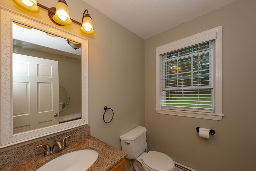 49 Point Of Pines Road Freetown, MA 02717 - Photo 10 of 32 a bathroom with a toilet sink a mirror and shower
