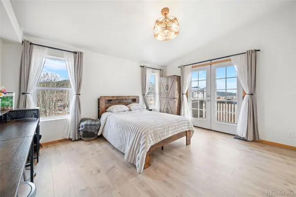 a bedroom with a bed a stove and a large window