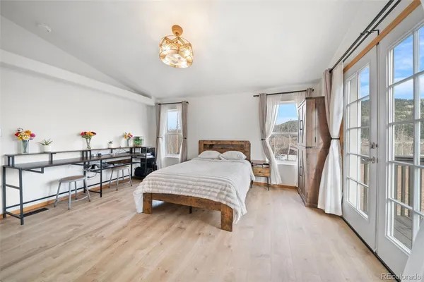 a spacious bedroom with a bed and a window