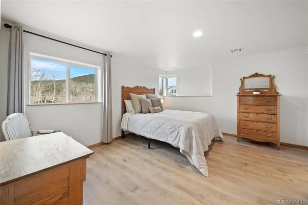 a bedroom with a bed and dresser