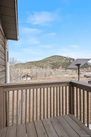 a view of a terrace with chairs and iron fence