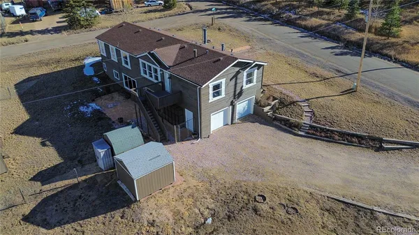 a view of a backyard with sitting area