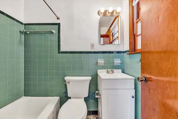 a bathroom with a sink mirror toilet and shower