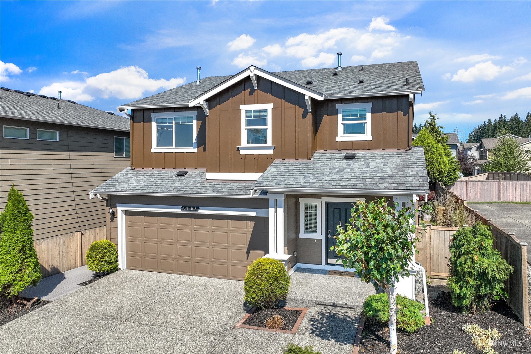 4203 167th Place Southeast Bothell, WA 98012 - Photo 1 of 38 a front view of a house with garden