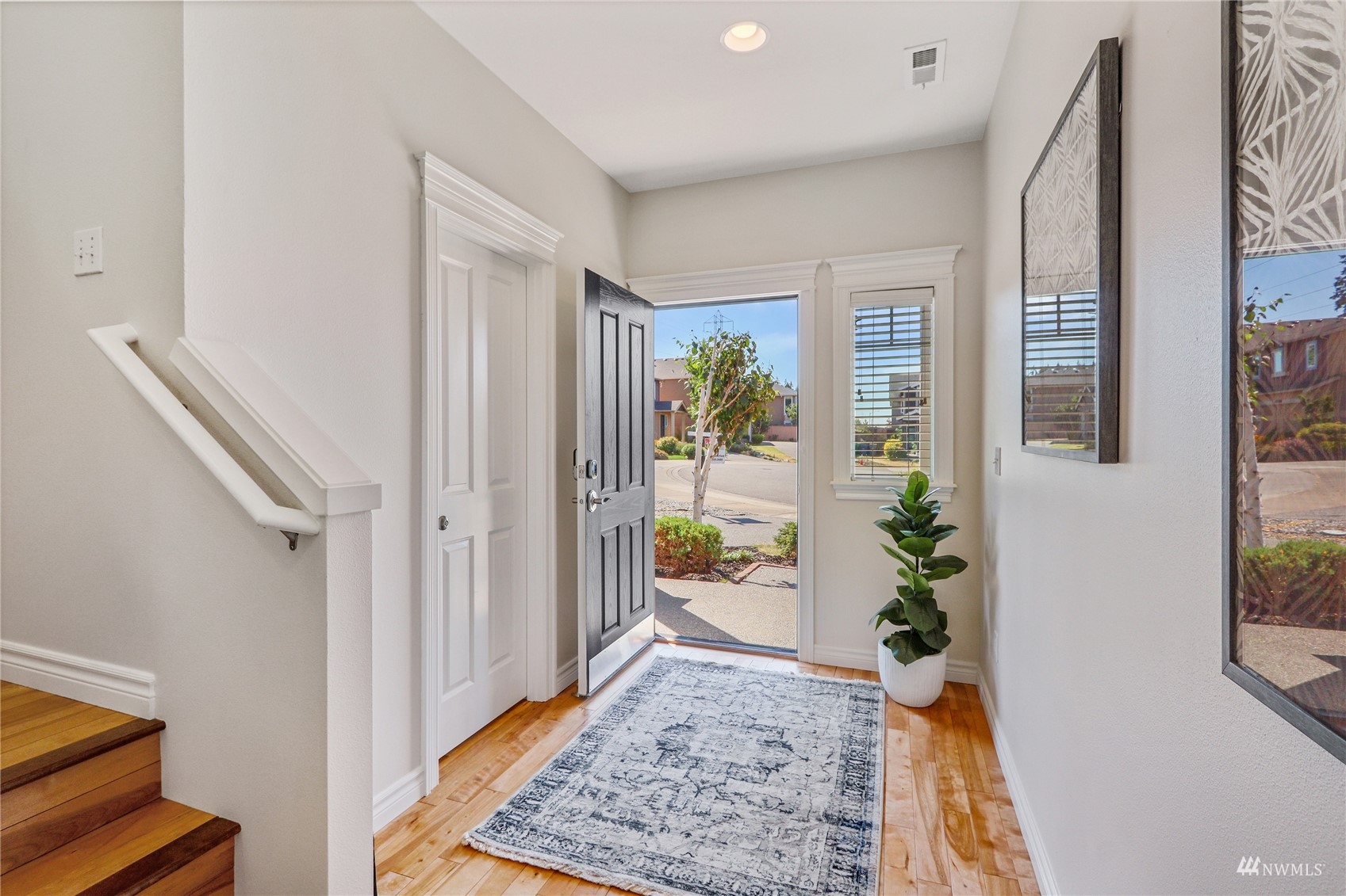 4203 167th Place Southeast Bothell, WA 98012 - Photo 3 of 38 a view of an entryway with wooden floor and a rug