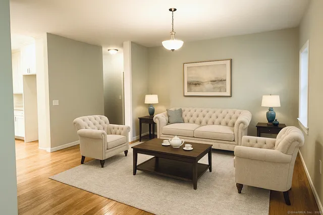 a living room with furniture and a lamp