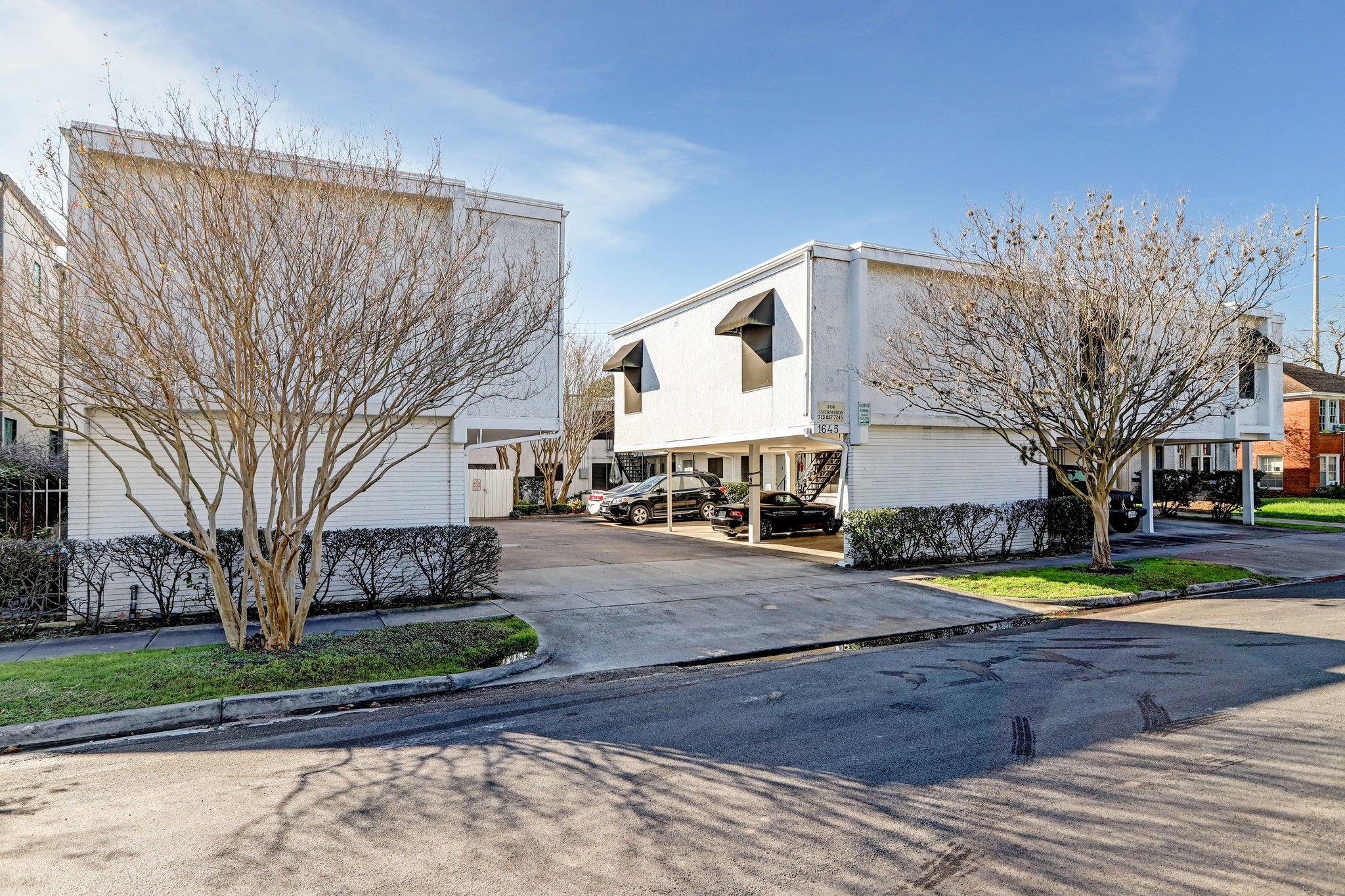 1645 West Main Street, Unit 13 Houston, TX 77006 - Photo 13 of 13 a front view of a house with a yard and large trees