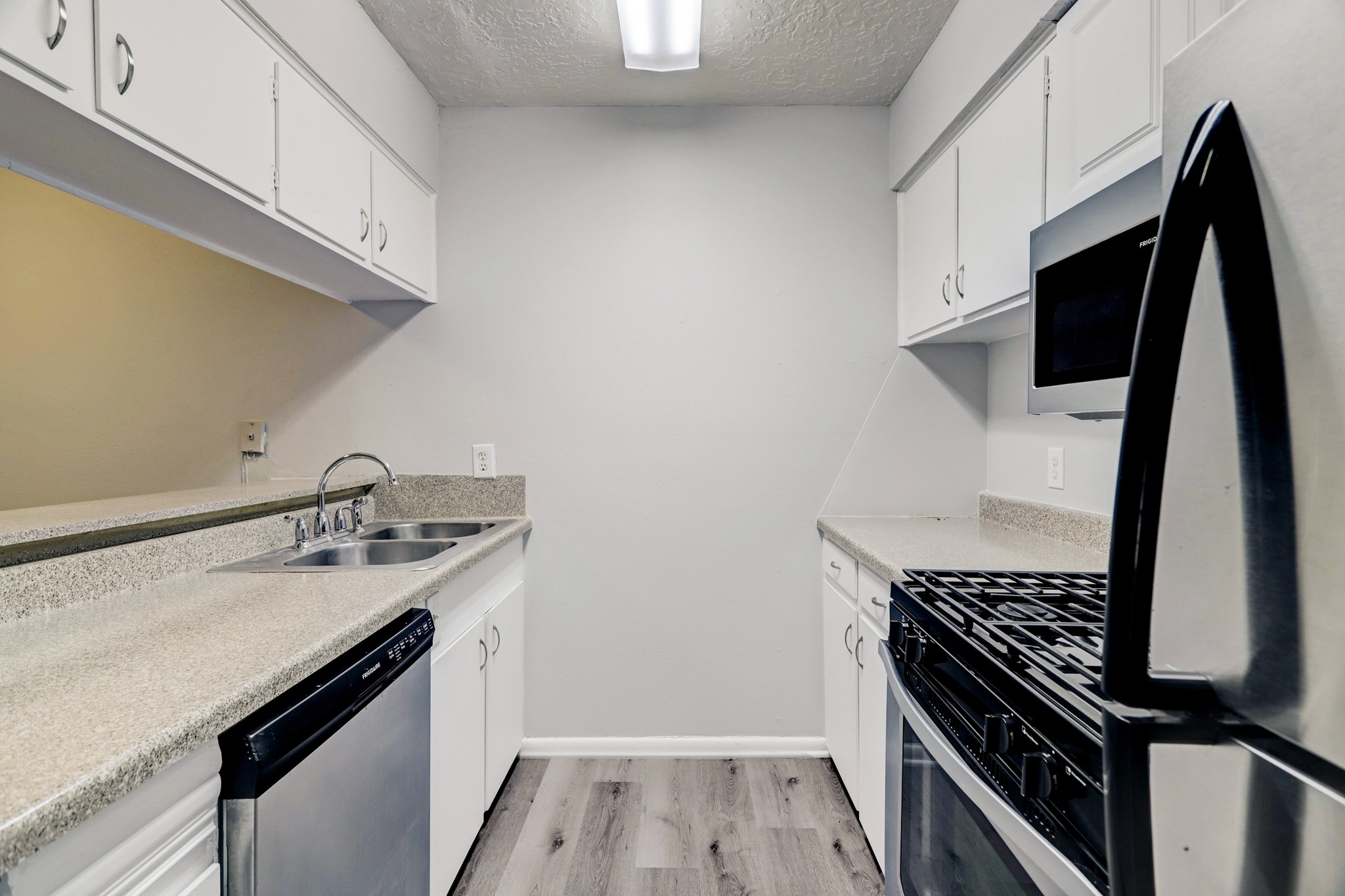 1645 West Main Street, Unit 13 Houston, TX 77006 - Photo 7 of 13 a kitchen with a sink stove and cabinets