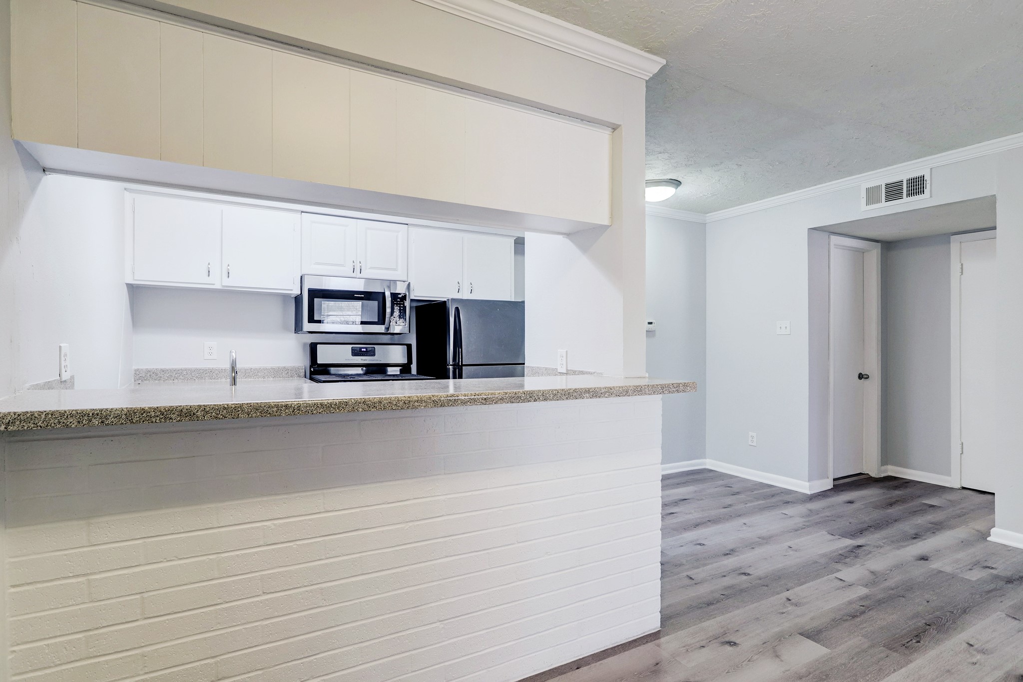 1645 West Main Street, Unit 13 Houston, TX 77006 - Photo 8 of 13 a view of kitchen with stainless steel appliances cabinets and wooden floor
