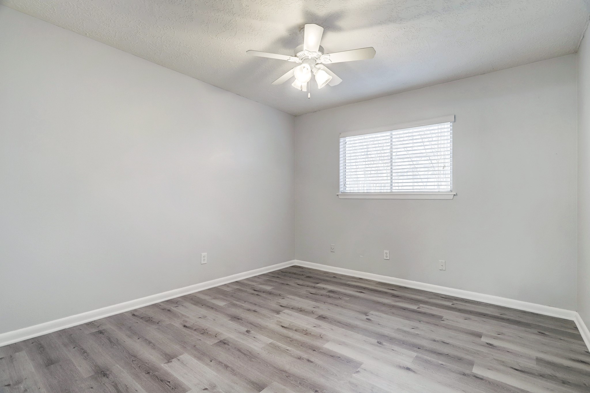 1645 West Main Street, Unit 13 Houston, TX 77006 - Photo 10 of 13 an empty room with wooden floor and windows