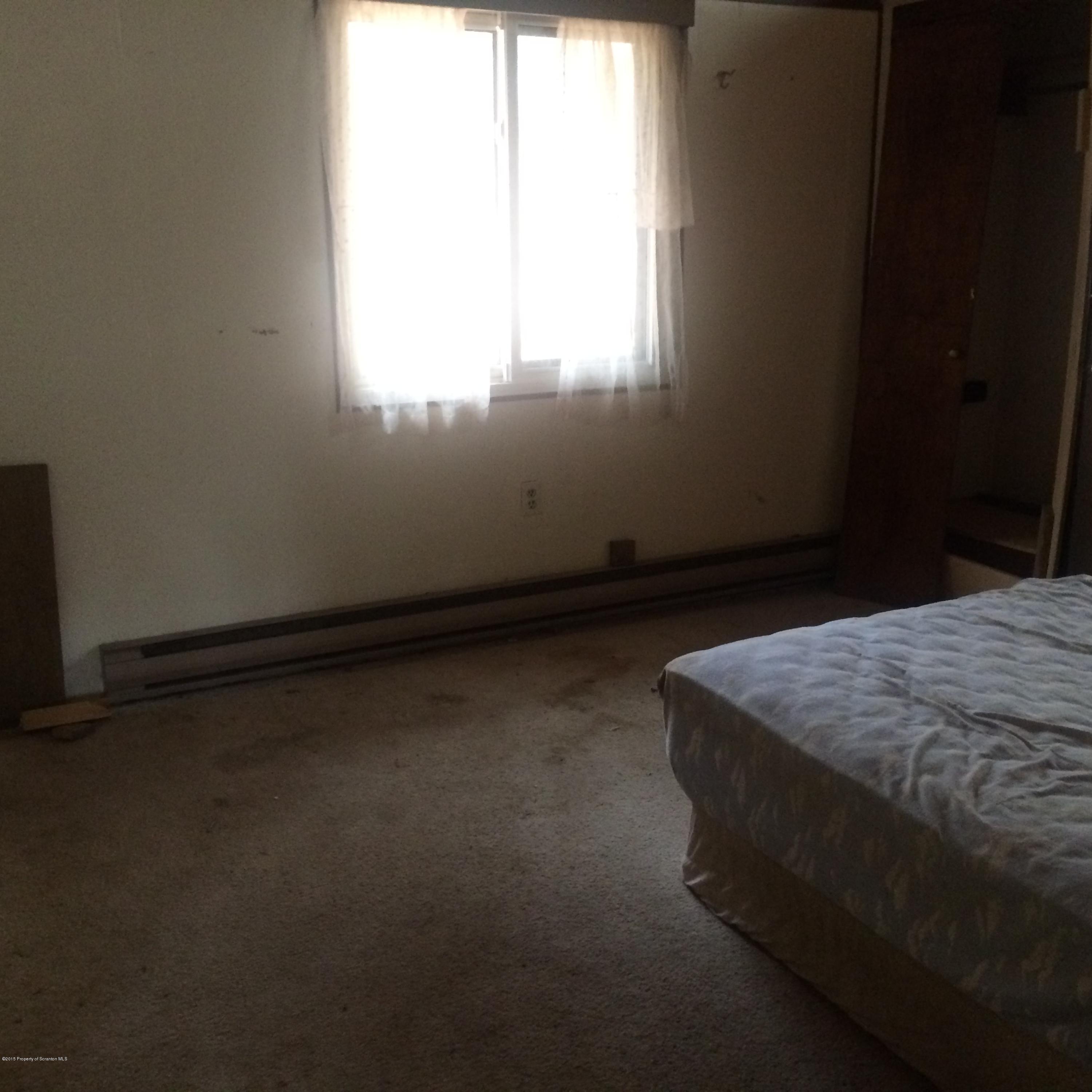 3322 Whengreen Road Nicholson, PA 18446 - Photo 12 of 15 a bed sitting in a bedroom next to a window